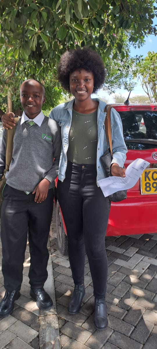 A smiling student at a school desk